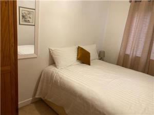 a small bedroom with a bed and a mirror at Apartment A321 in Northampton
