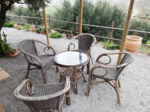a group of chairs and a table and a table and chairs at Wooden House at the Mountain-private in Paránimfoi