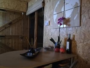 a table with a bottle of wine and flowers on it at Wooden House at the Mountain-private in Paránimfoi