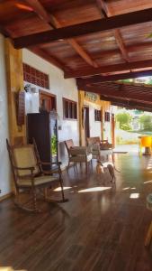 a living room with a dog standing in a room at Vila Bello Pontal in Coruripe