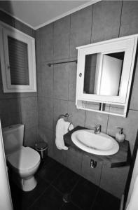 a bathroom with a toilet and a sink and a mirror at MarKaMar in Loutraki
