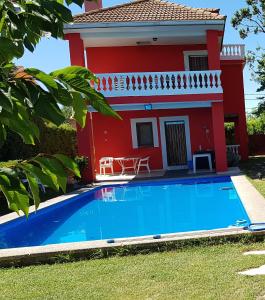 a house with a blue swimming pool in front of it at El Campo in Zaragoza