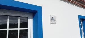 a door with a sign on the side of a building at Casa da Bisa - Santa Maria - Açores in Santa Bárbara