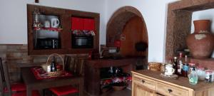 a kitchen with wooden cabinets and a sink and a mirror at Casa da Bisa - Santa Maria - Açores in Santa Bárbara