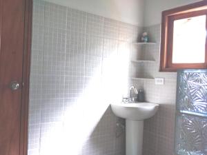 a bathroom with a white sink and a mirror at Bed & Breakfast T.T in Río Hato