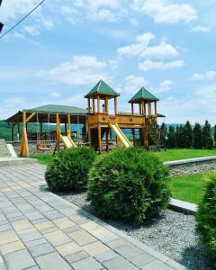 a playground with a slide in a park at Drinska Idila apartmani in Vrhpolje