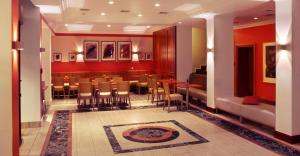 a restaurant with a table and chairs in a room at Best Western Hotel Leipzig City Centre in Leipzig