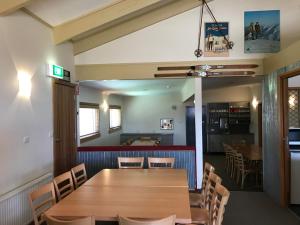 a dining room with a wooden table and chairs at Cooroona Alpine Lodge in Falls Creek