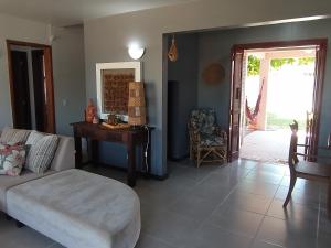 a living room with a couch and a table at Casa de veraneio Lar doce mar in Capão da Canoa