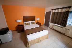 a bedroom with a bed and a air conditioner at Stay Inn Suite in Stockton