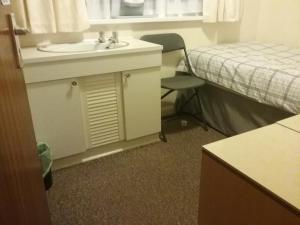 a hotel room with a sink and a bed at Y-NOT Guest House in Boston