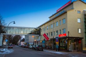 a building with a pedestrian bridge over a street at SpaHotel Hamina in Hamina