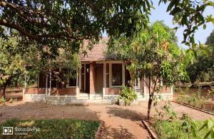 a brick house with a tree in front of it at GREEN VISION RESORT in Murbād