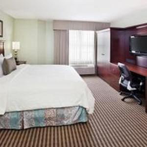 a hotel room with a large bed and a desk at Holiday Inn Express Hotel & Suites Atlanta Buckhead, an IHG Hotel in Atlanta