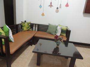 a living room with a couch and a table at Omah Ambarukmo in Yogyakarta