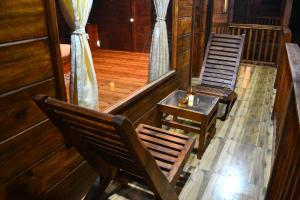 two chairs and a table in a room at Radhika Eco Resort(Odonata) in Arambol