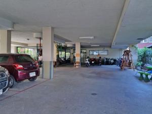 a parking garage with a car parked in it at Boonthavon in Chiang Mai