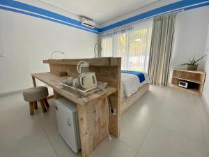 a bedroom with a bed and a desk with a sink at Kura Kura Divers Lodge in Amed