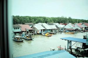 a group of houses and boats in the water at Ks Homestay in Taiping
