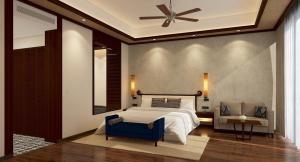 1 dormitorio con 1 cama y ventilador de techo en Taj Bekal Resort & Spa, Kerala, en Bekal