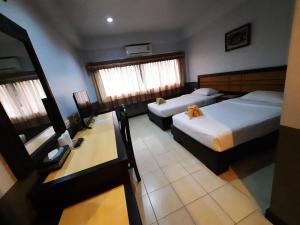Postel nebo postele na pokoji v ubytování Ariya inn Chiangrai