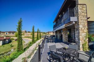 a patio with tables and chairs in front of a building at Hotel Boutique by BlackSeaRama, a Small Luxury Hotels of the World member in Balchik
