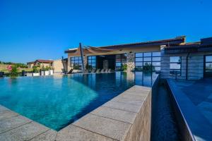 a swimming pool in front of a house at Boutique Hotel by BlackSeaRama in Balchik