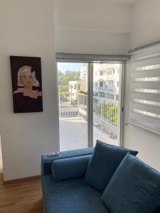 a living room with a blue couch in front of a window at 2 Bedroom apartment in Nicosia's center-11 in Nicosia