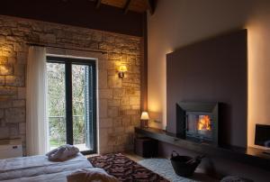 a bedroom with a fireplace and a bed and a window at Levidi Suites in Levidi
