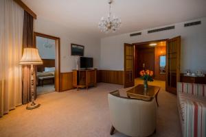 a living room with a table and a couch at President Hotel in Moscow