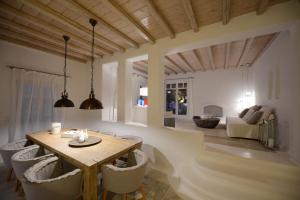 a dining room with a table and chairs at Villa Azurite with heated pool by Diles Villas in Psarou