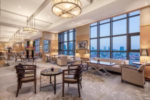 a lobby with a large room with windows at InterContinental Shanghai Pudong, an IHG Hotel in Shanghai