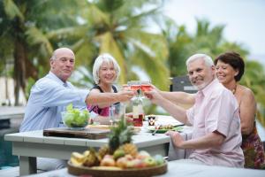 a group of people sitting at a table drinking wine at Domaine de Grand Baie in Grand-Baie