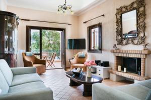 a living room with a couch and a fireplace at Villa Cara in Kourkoumelata