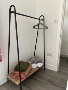 a room with a shelf with towels and a lamp at Union Street Apartment in Hawick