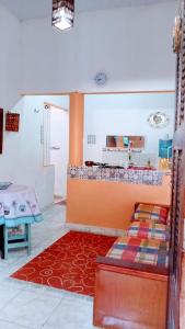 a living room with a bed and a table at Villamar temporada -praia do futuro in Fortaleza