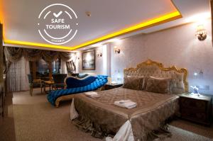 A bed or beds in a room at Grand Ambiance Hotel