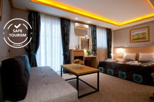 A bed or beds in a room at Grand Ambiance Hotel