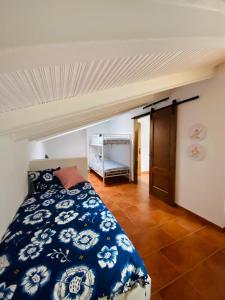 a bedroom with a blue and white bed in a room at LA CRUZ DE LA ATALAYA in Benamahoma