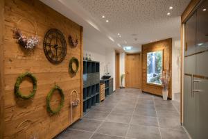 a hallway with a wooden wall with wreaths on it at Haus Sattelblick in Sankt Anton am Arlberg