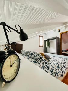 a bedroom with a clock on a bed at LA CRUZ DE LA ATALAYA in Benamahoma +30 photos