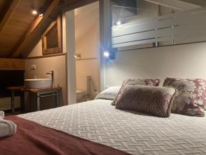 a bedroom with a bed and a sink in a room at Los Chozos de la Braña in Brañosera