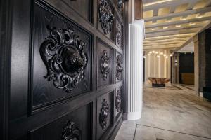 a hallway with wood paneling and a wall with a clock on it at Shato Hotel in Omsk