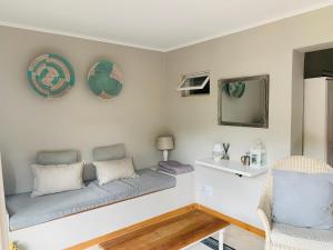 a living room with a couch and a mirror at Eight on Tuin in Franschhoek