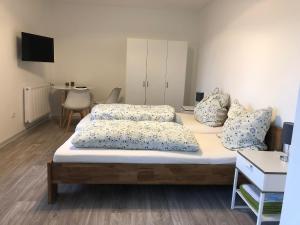 a bedroom with a bed with two pillows on it at Pension Jägerschenke in Luhe-Wildenau