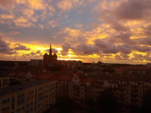a view of a city with a sunset at Centrum 9 in Kołobrzeg