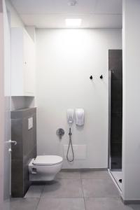 
a bathroom with a toilet, sink, and shower stall at Ostelzzz Milano in Milan

