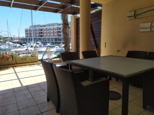 a dining room with a table and chairs and a marina at Unique 3 Bedroom in V A Waterfront in Cape Town