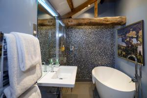 a bathroom with a tub and a sink and a bath tub at The Castle Inn in Harrogate