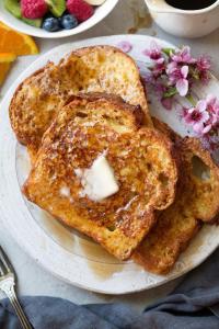 two pieces of toast on a plate with butter at Solo Victoria Hotel in New Delhi